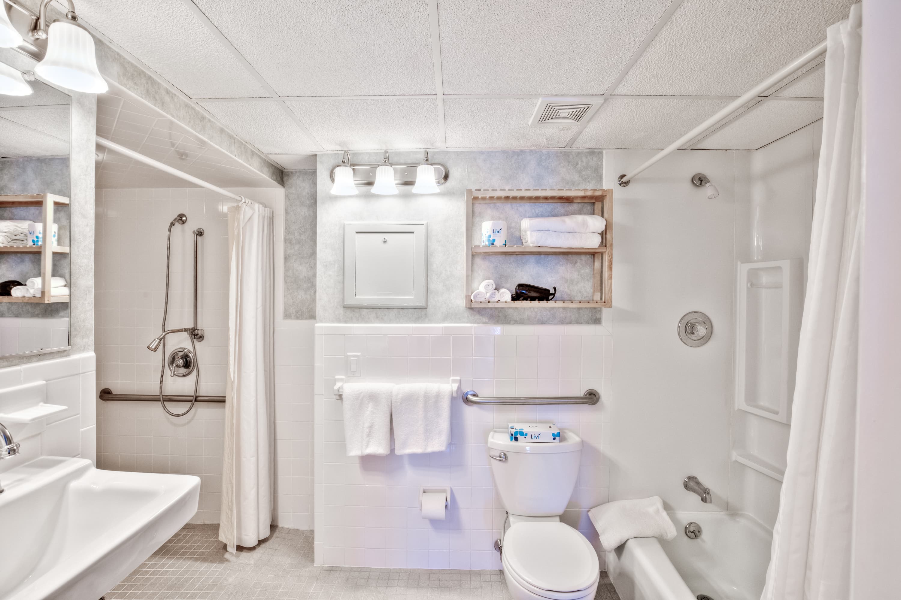 The updated accessible bathroom has a roll-in shower