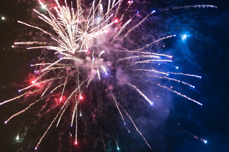 Colorful fireworks explode in the night sky, creating a vibrant display.