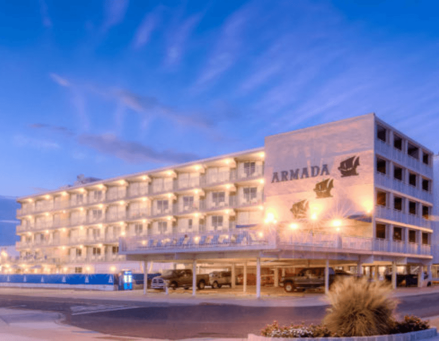 The Armada hotel illuminated at dusk with a blue sky backdrop.