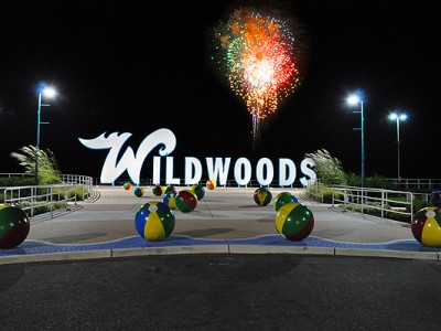 Wildwood NJ Sign at night and fireworks on the beach