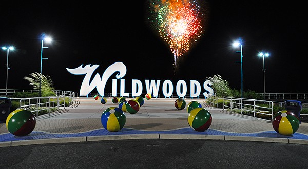 Wildwood NJ Sign at night and fireworks on the beach